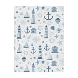Nautical minky baby blanket draped over a crib