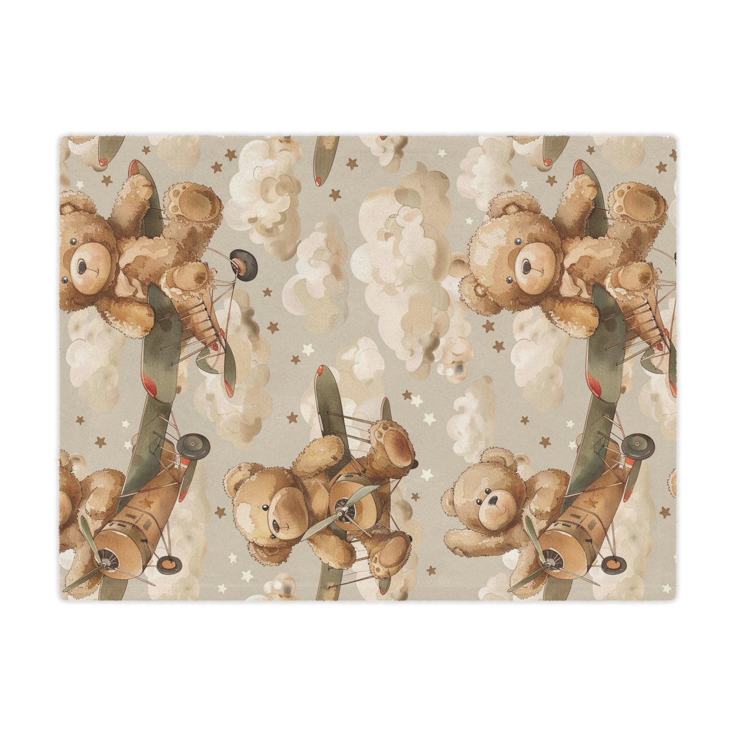 Close detail of a teddy bear flying a biplane on the minky blanket