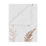 Boho Botanical minky baby blanket draped over a crib