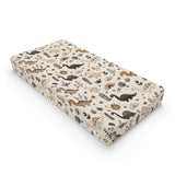 Meadow Dinosaurs changing pad cover on a nursery changing table