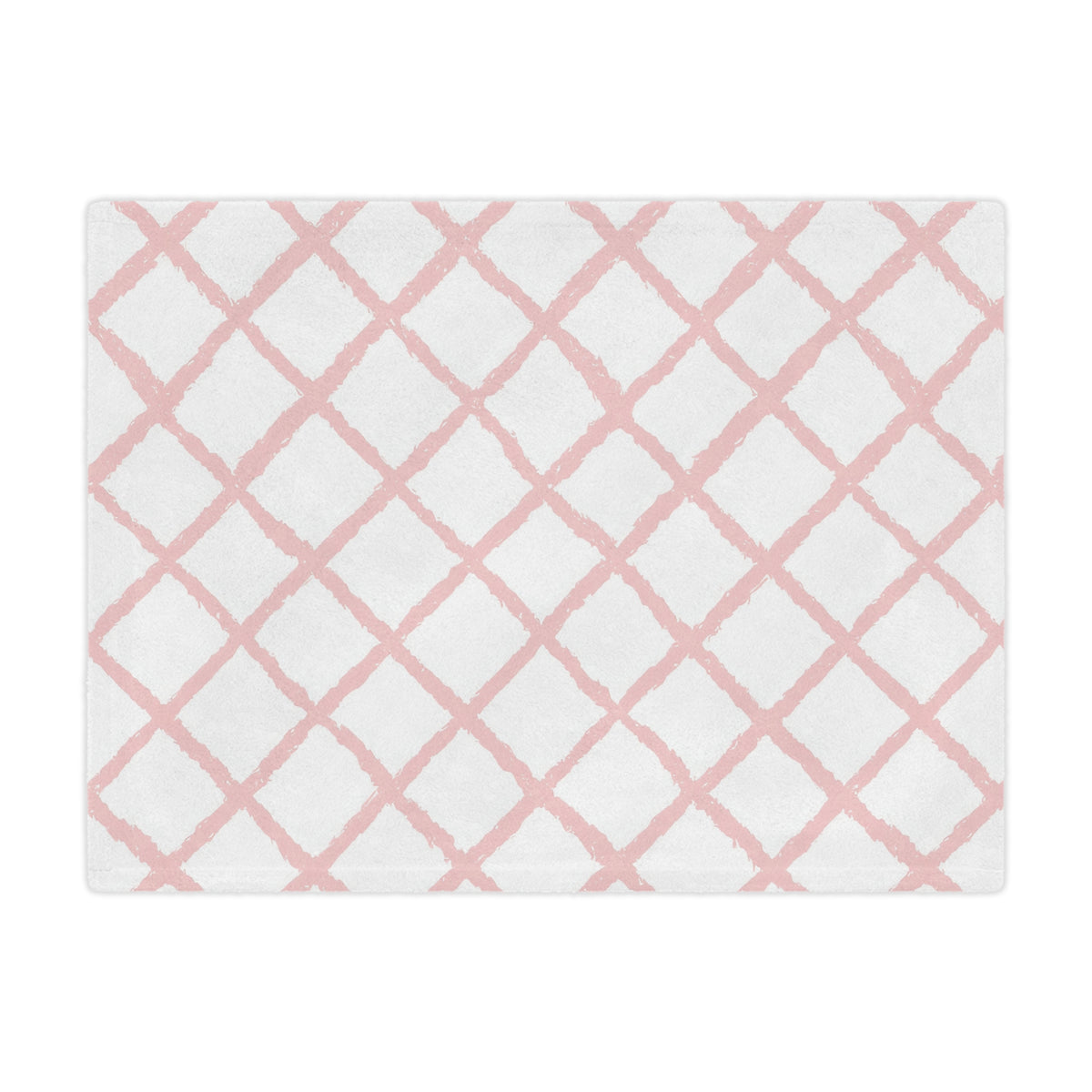 Close-up of the plush minky texture on a pink trellis baby blanket