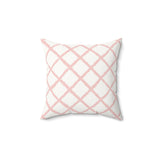 Pink trellis decorative nursery pillow on a glider chair