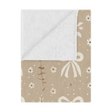 Ribbon Meadow minky baby blanket draped over a crib