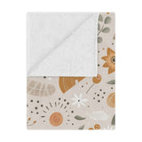 Wildflower Rainbow minky baby blanket draped over a crib