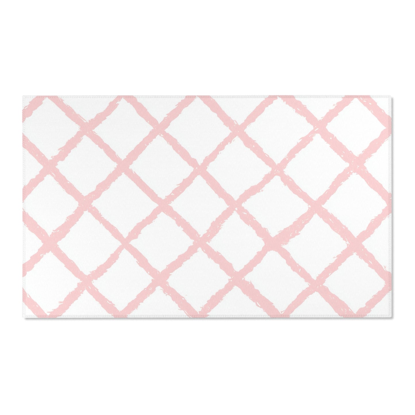 Pink lattice area rug defining a nursery play area