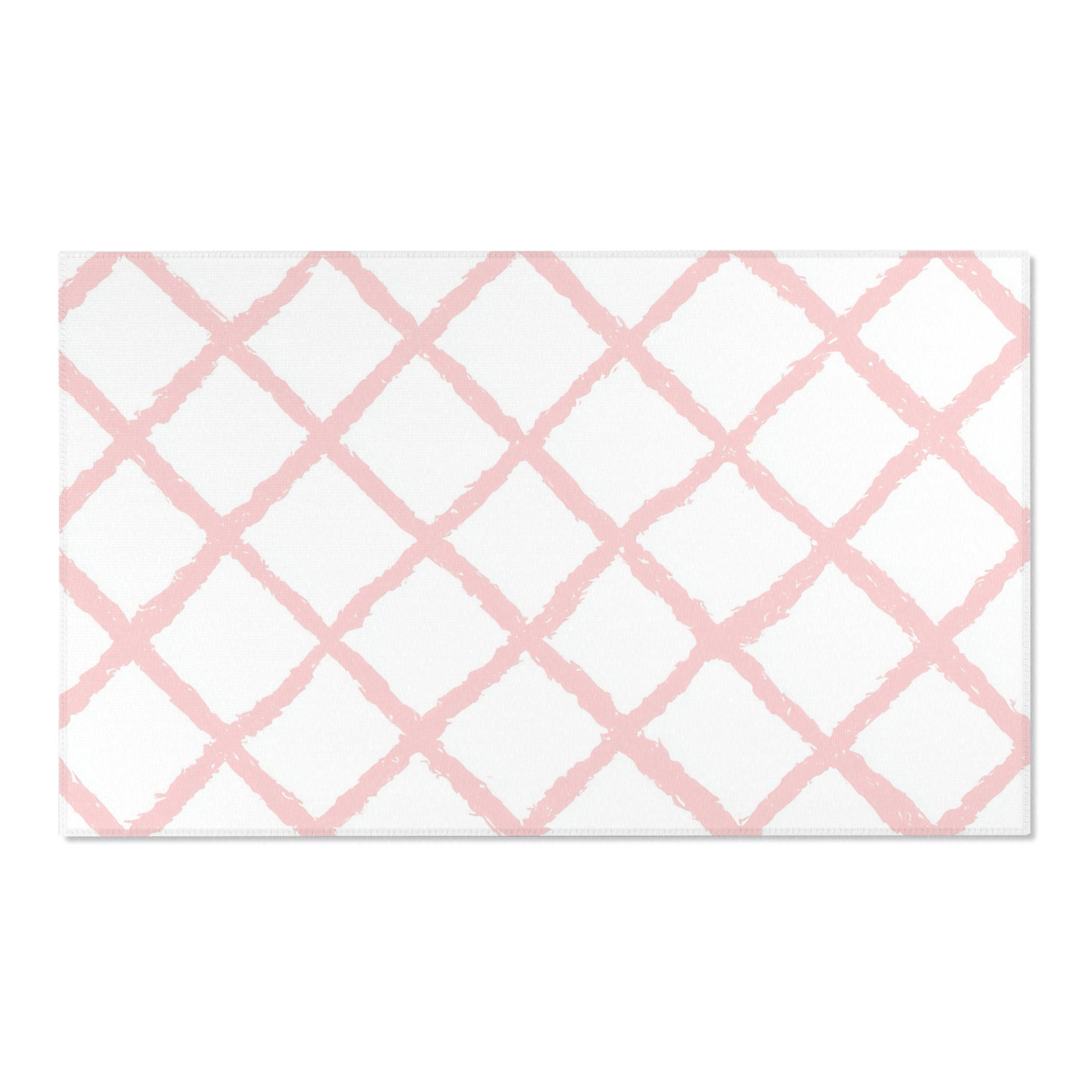 Pink lattice area rug defining a nursery play area