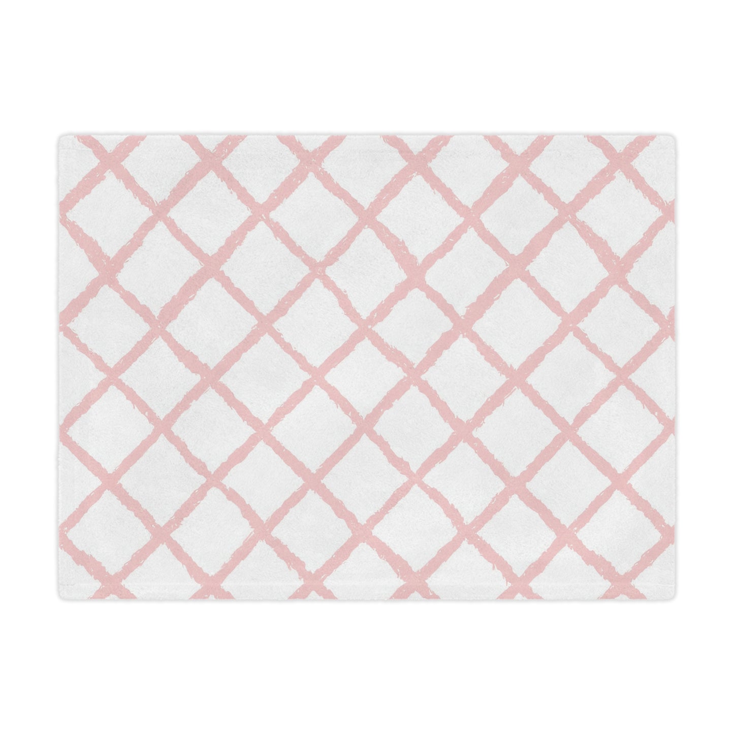 Close-up of the plush minky texture on a pink trellis baby blanket