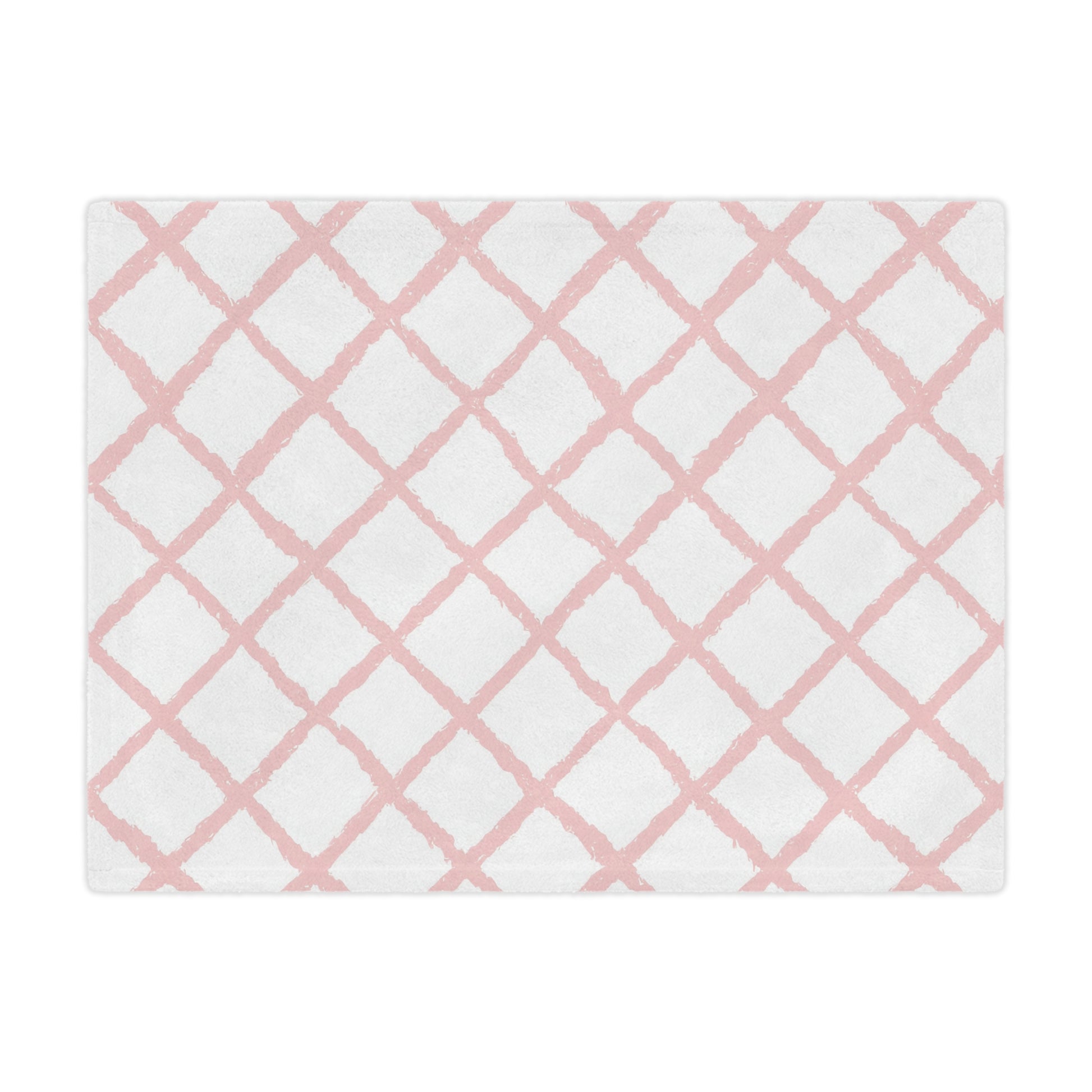 Close-up of the plush minky texture on a pink trellis baby blanket