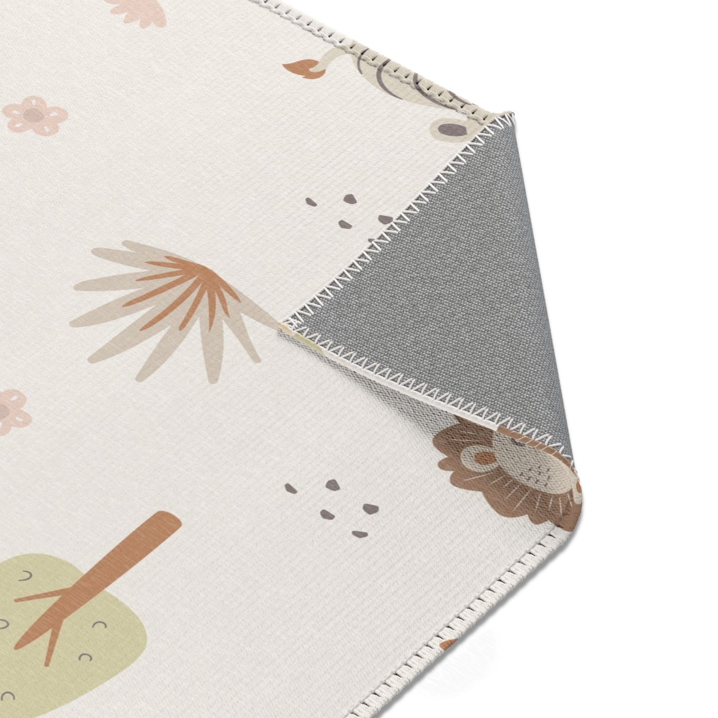 Sleepy safari rug beside a nursery glider chair