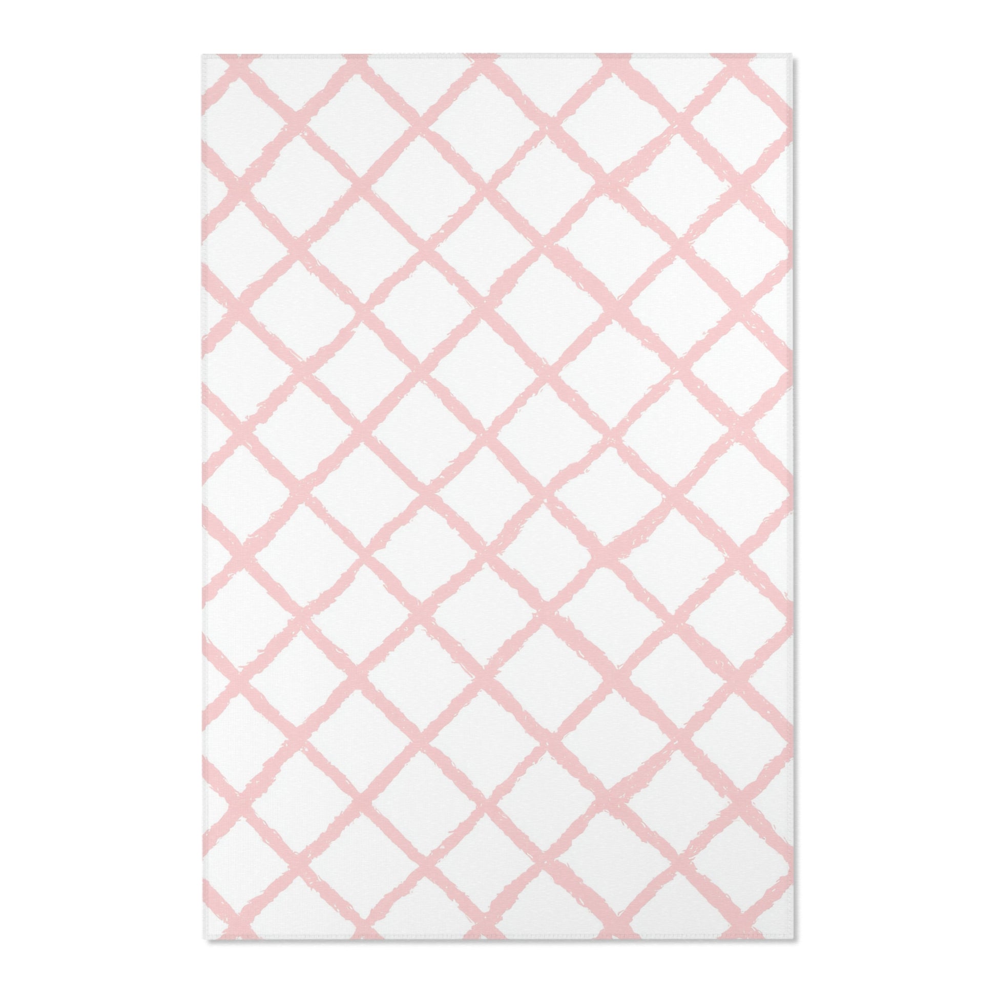 Close-up of the hand-painted pink trellis print on a nursery rug