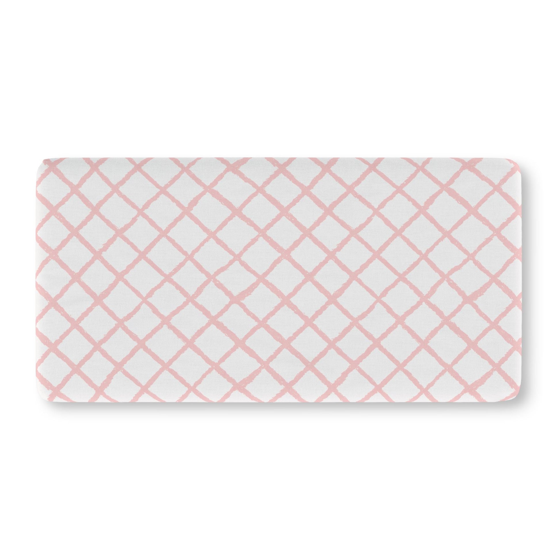 Soft pink lattice crib sheet showing the fitted elasticated corner