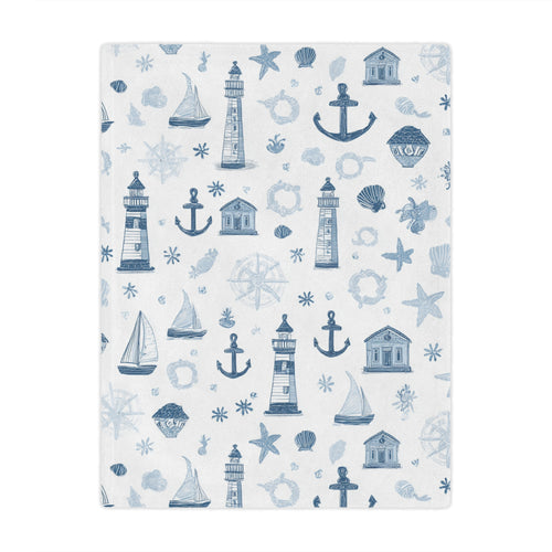 Nautical minky baby blanket draped over a crib