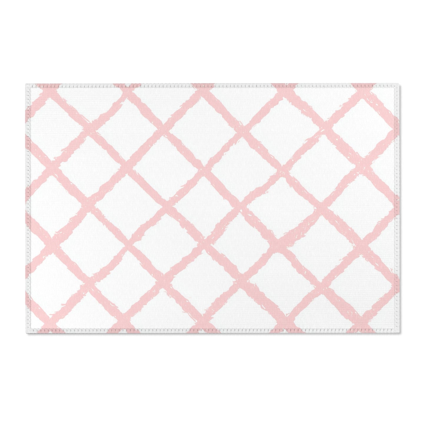 Washable pink trellis area rug under a nursery crib