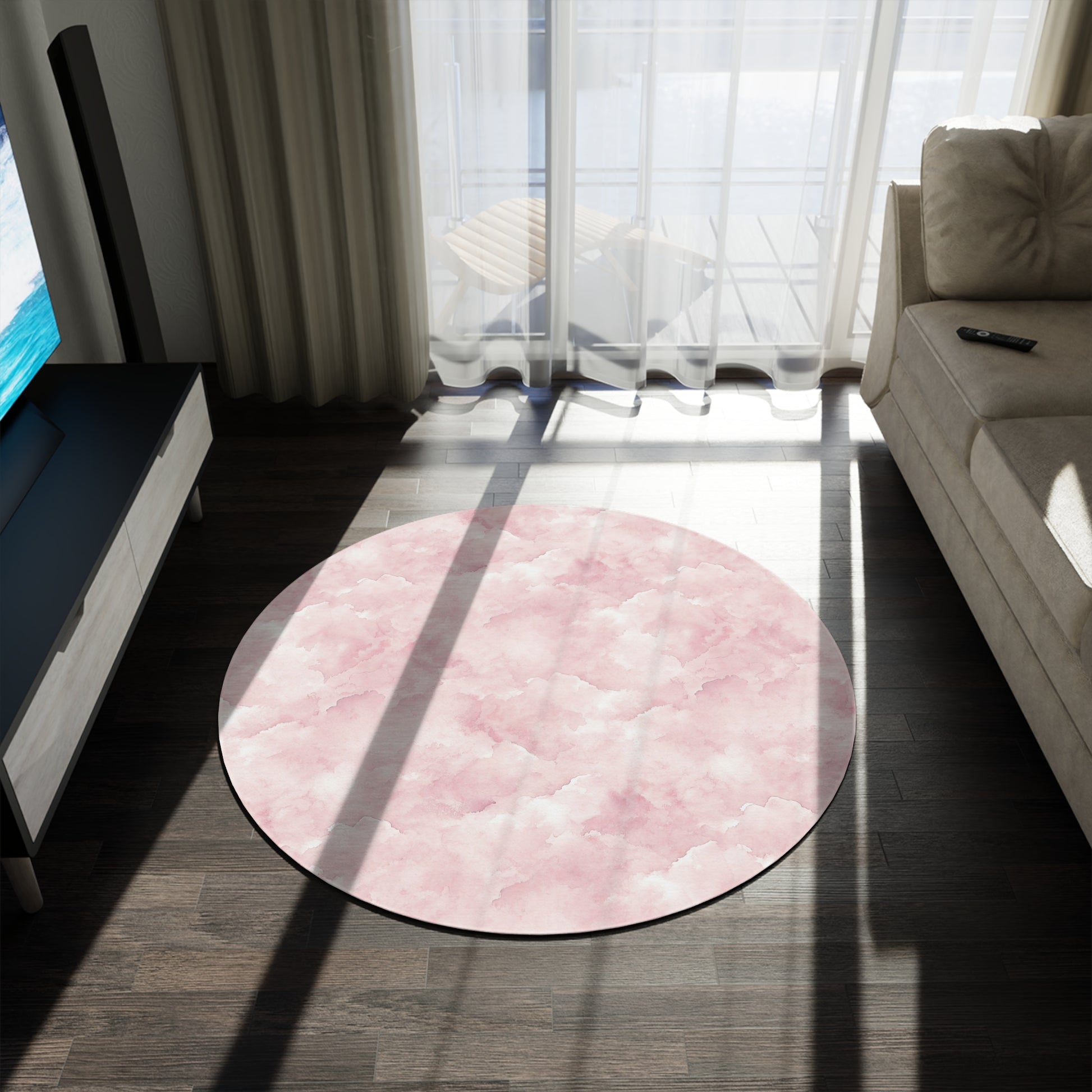 Close-up of the soft pink watercolor cloud print on a round nursery rug