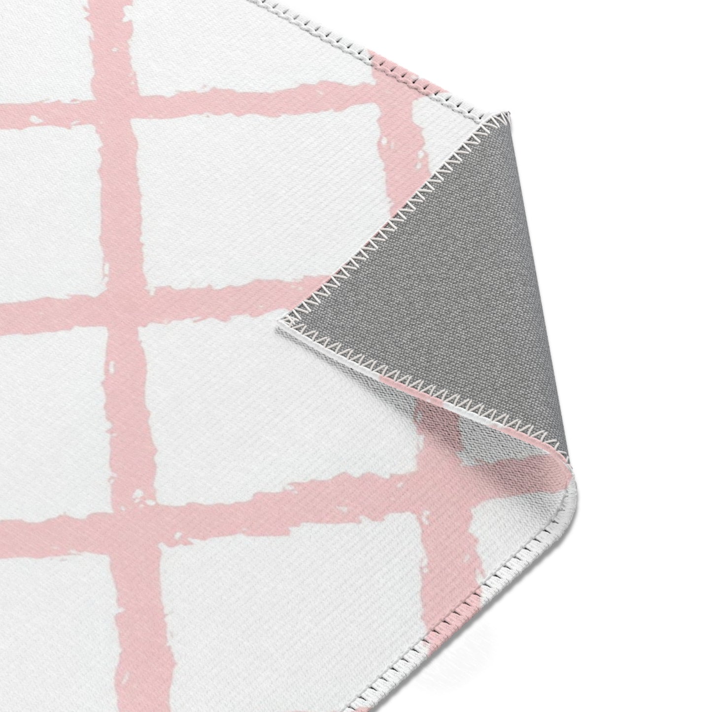 Pink trellis nursery rug edge and pile detail