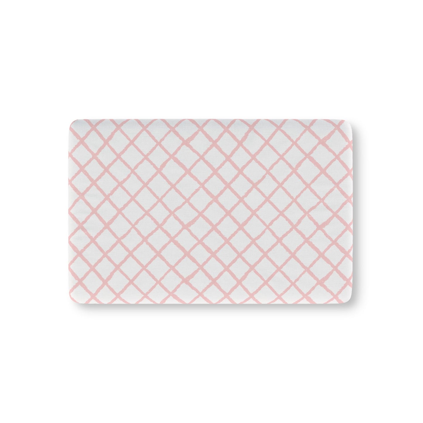 Pink trellis fitted crib sheet on a nursery crib mattress