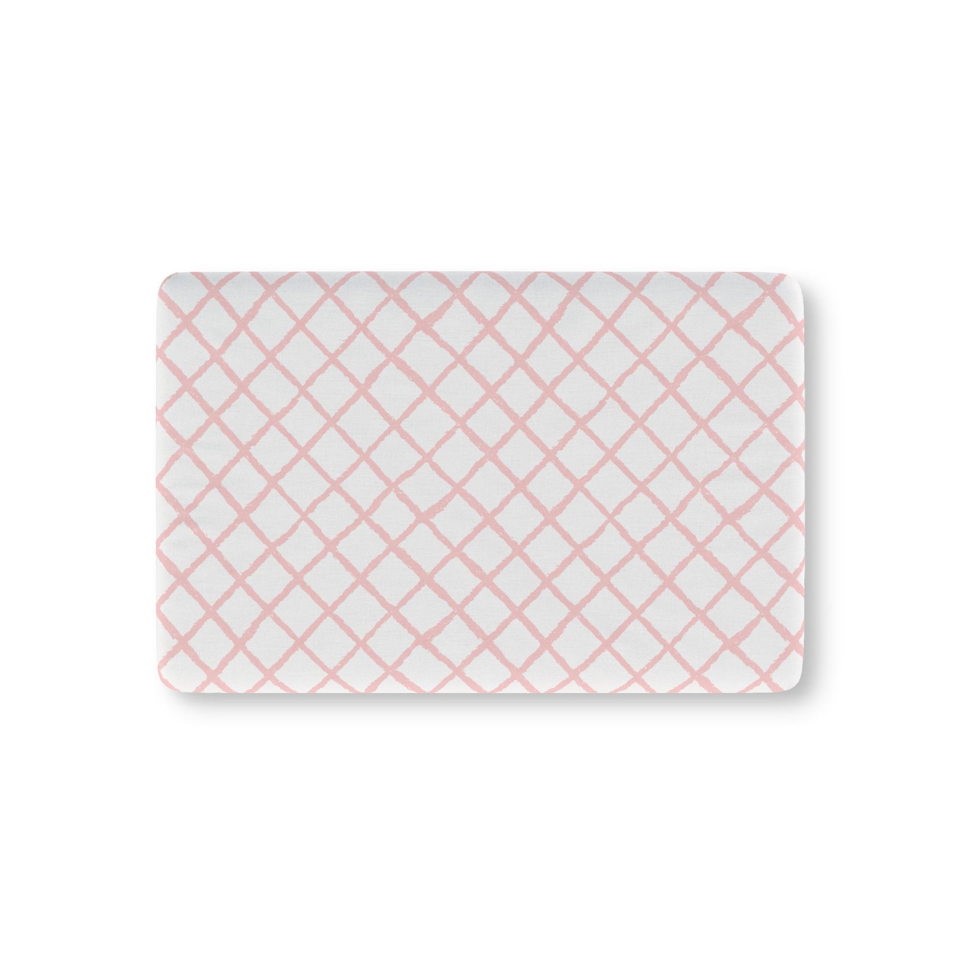 Pink trellis fitted crib sheet on a nursery crib mattress