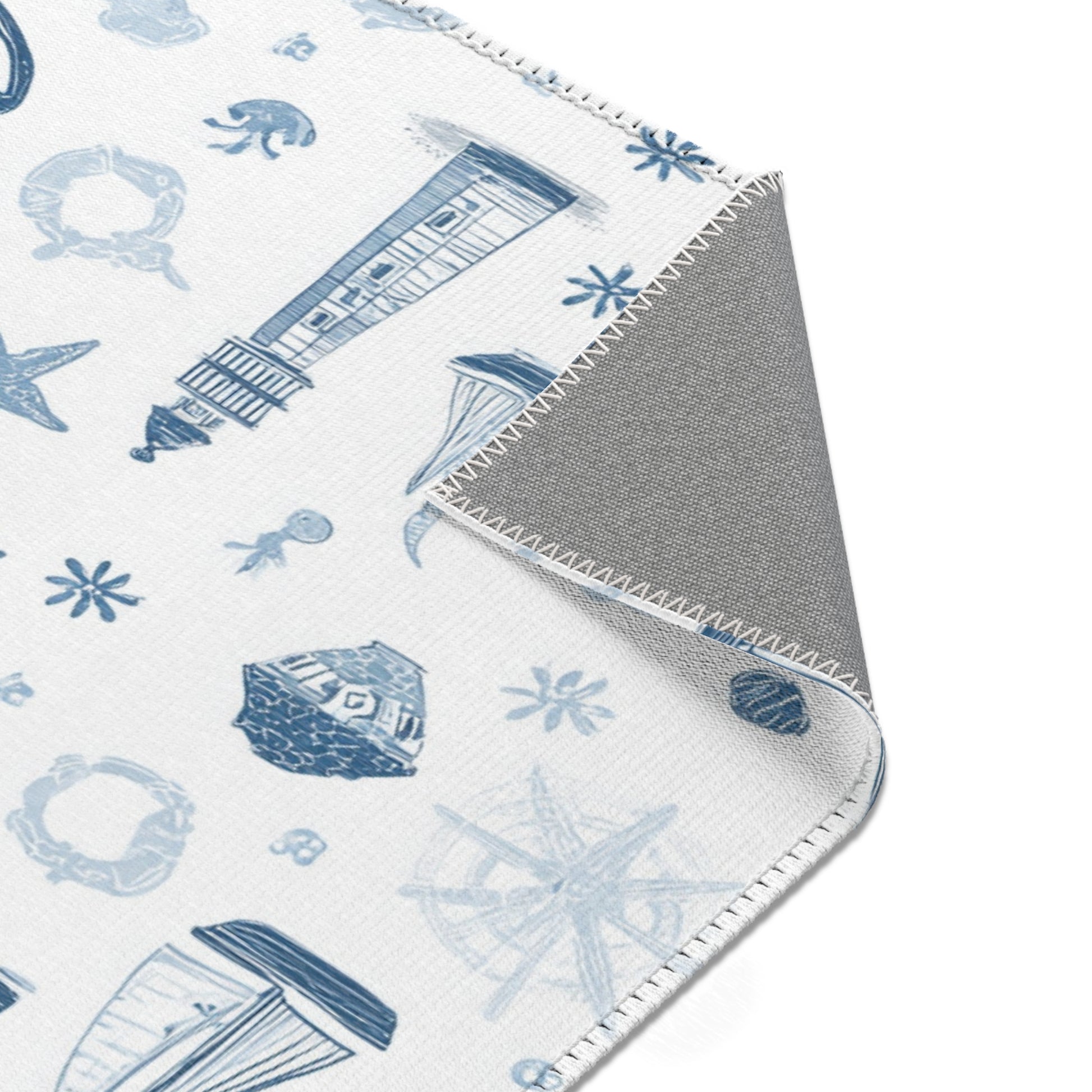 Nautical rug beside a nursery glider chair