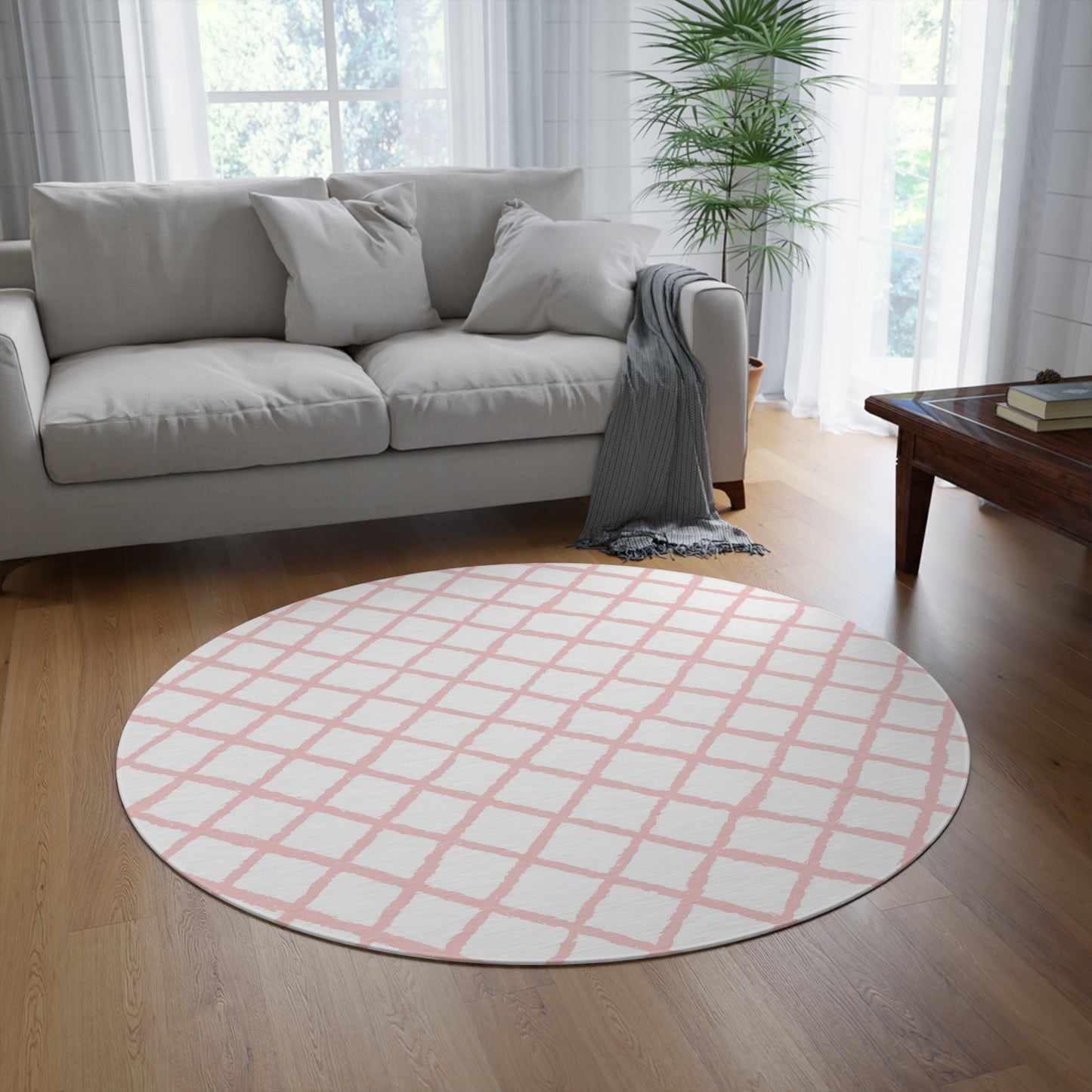 Pink trellis round rug styled under a nursery crib