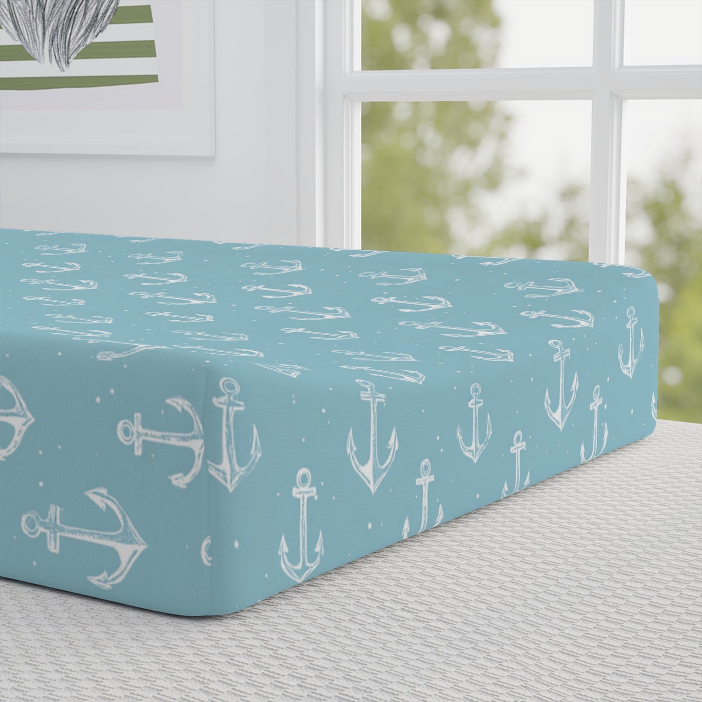 Close-up of the anchor print on a nursery changing pad cover