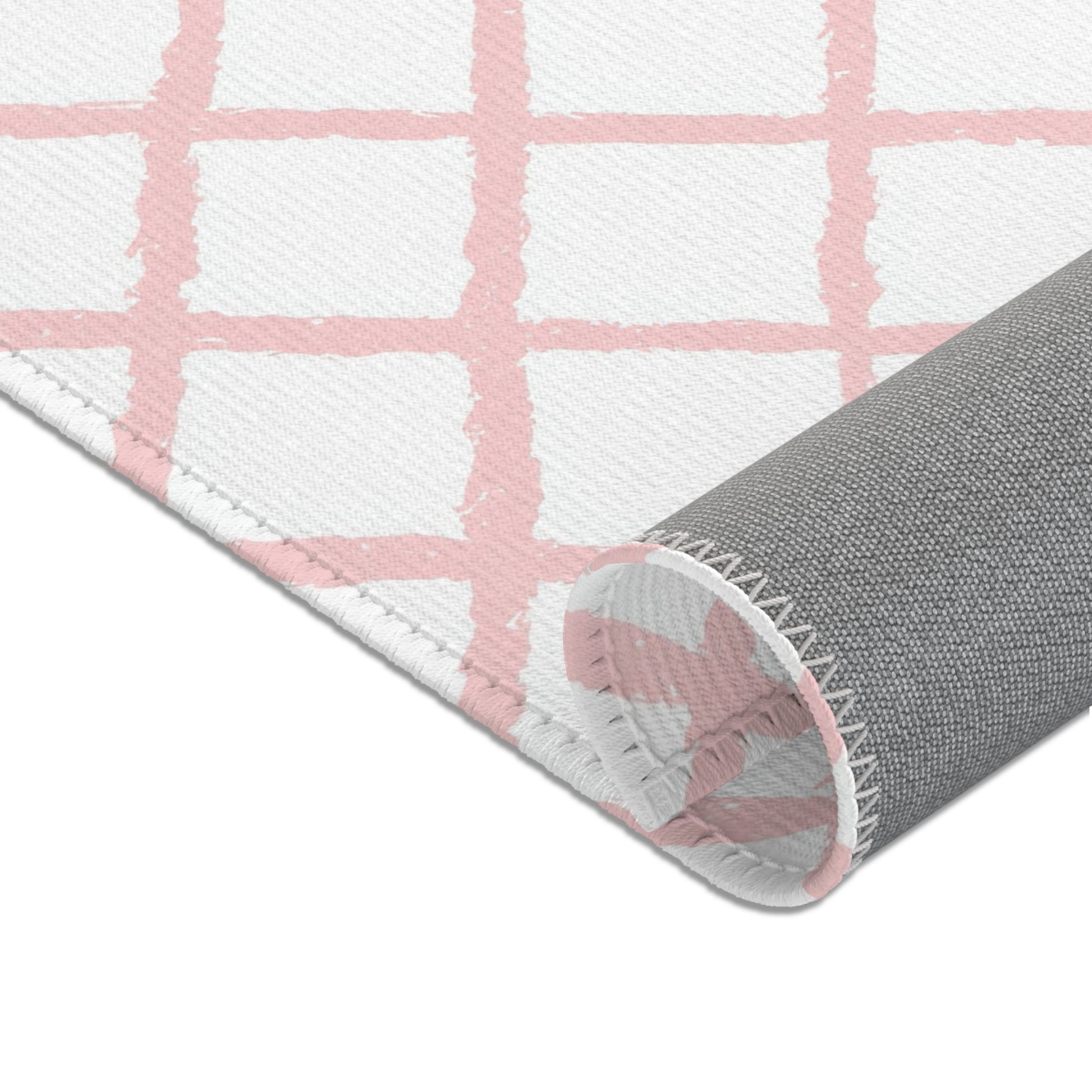 Soft pink lattice nursery rug shown at full size