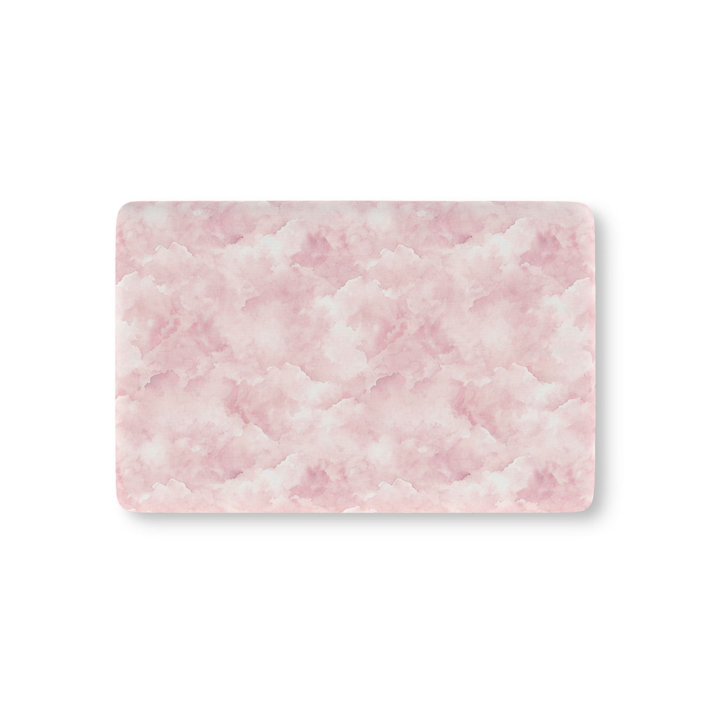 Pink watercolor clouds fitted crib sheet on a nursery crib mattress