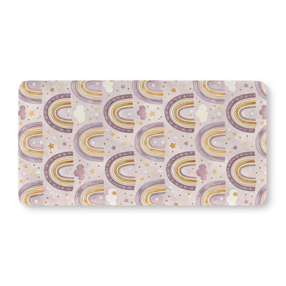 Fitted crib sheet with purple and gold rainbows on pale lilac