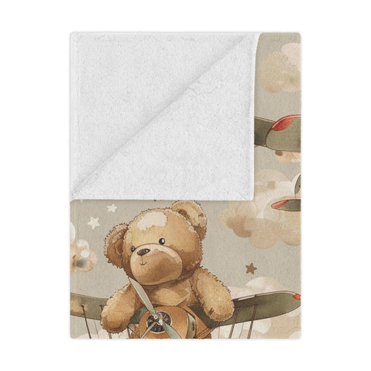 Aviator Bears minky baby blanket draped over a crib