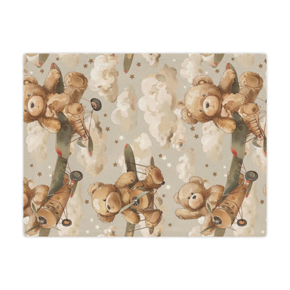 Close detail of a teddy bear flying a biplane on the minky blanket