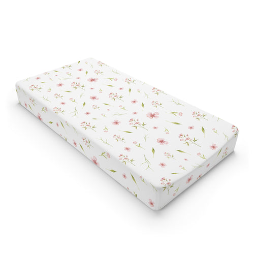 Blush Blossom changing pad cover on a nursery changing table