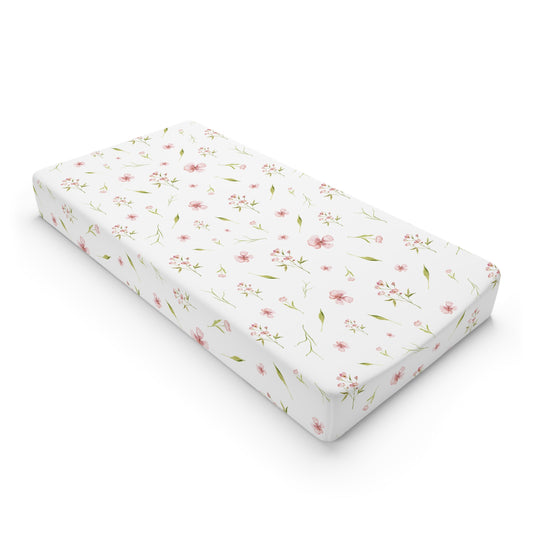 Blush Blossom changing pad cover on a nursery changing table
