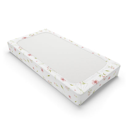Fitted pink floral changing pad cover with elastic edges