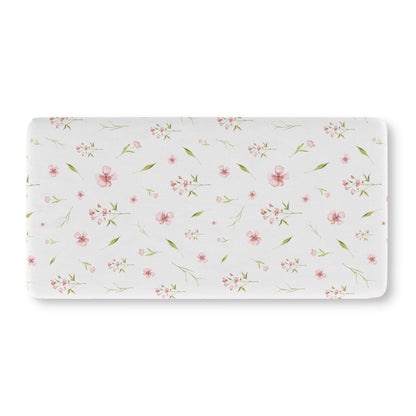 Pink watercolour floral crib sheet on a standard crib mattress