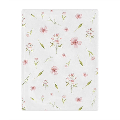Pink watercolour floral minky baby blanket in a nursery