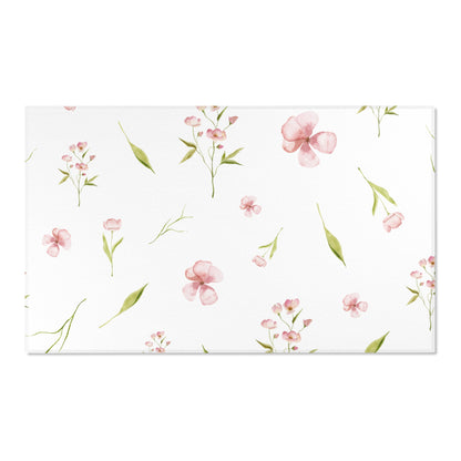 Watercolour floral area rug in a soft neutral baby room