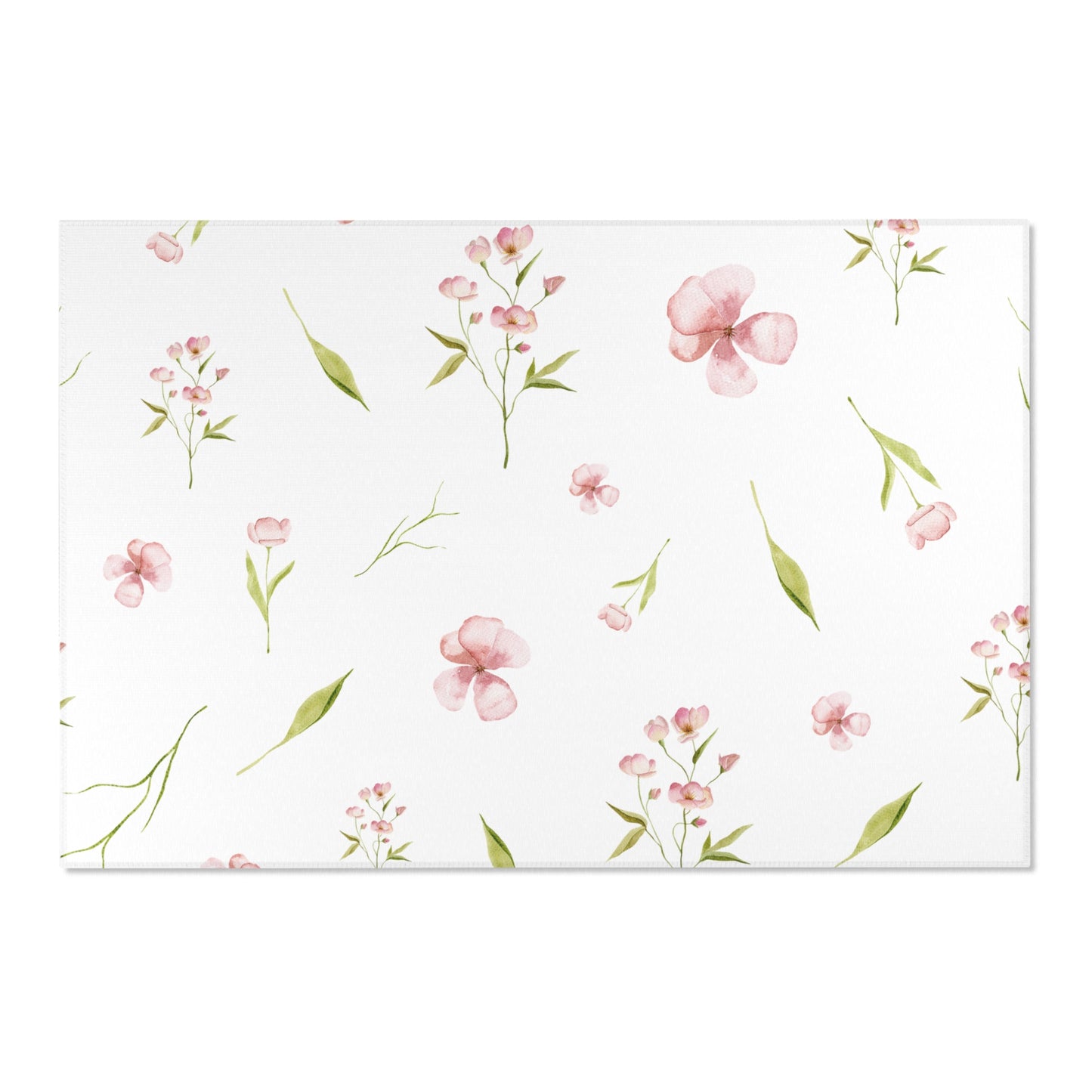 Pink and green floral nursery rug on a wooden floor