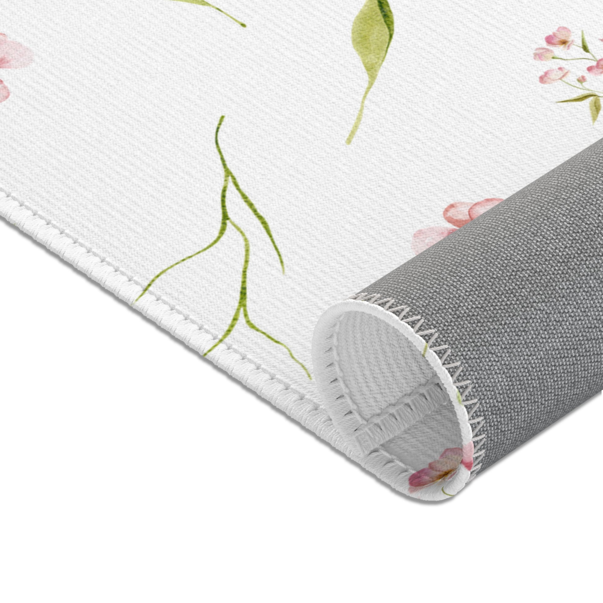 Pink floral nursery rug under a crib