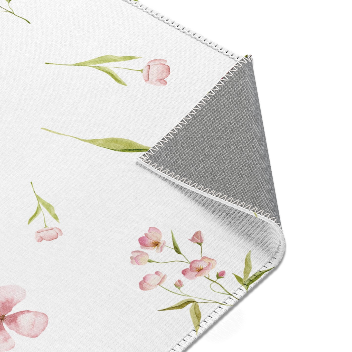 Soft pink floral rug with green leaf detail