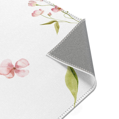 Blush Blossom floral area rug on a light wood floor