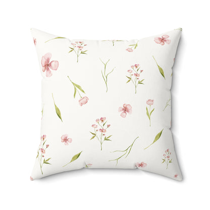 Dusty pink floral cushion on a nursery chair
