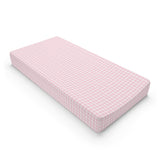 Blush Gingham changing pad cover on a nursery changing table