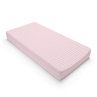 Blush Gingham changing pad cover on a nursery changing table