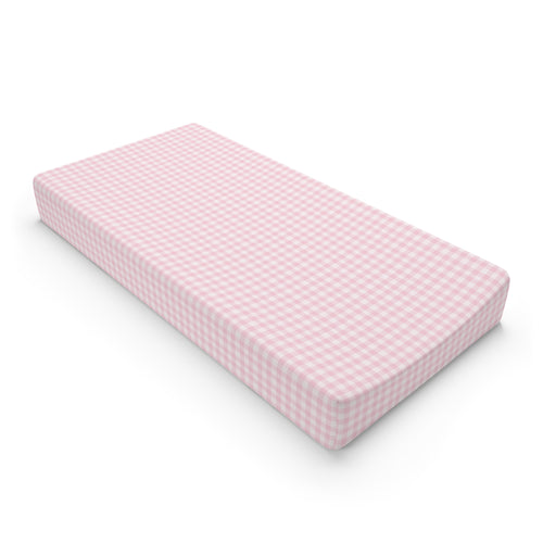 Blush Gingham changing pad cover on a nursery changing table