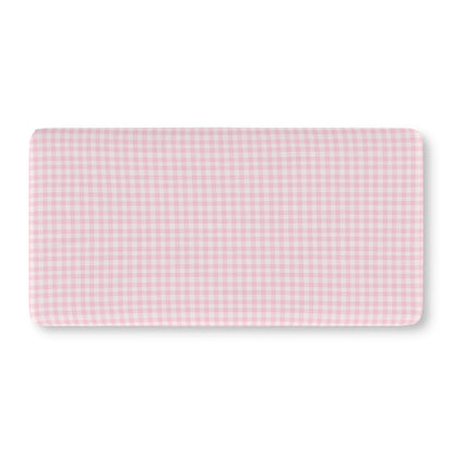 Pink gingham crib sheet on a standard crib mattress