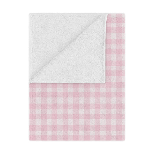 Blush Gingham minky baby blanket draped over a crib