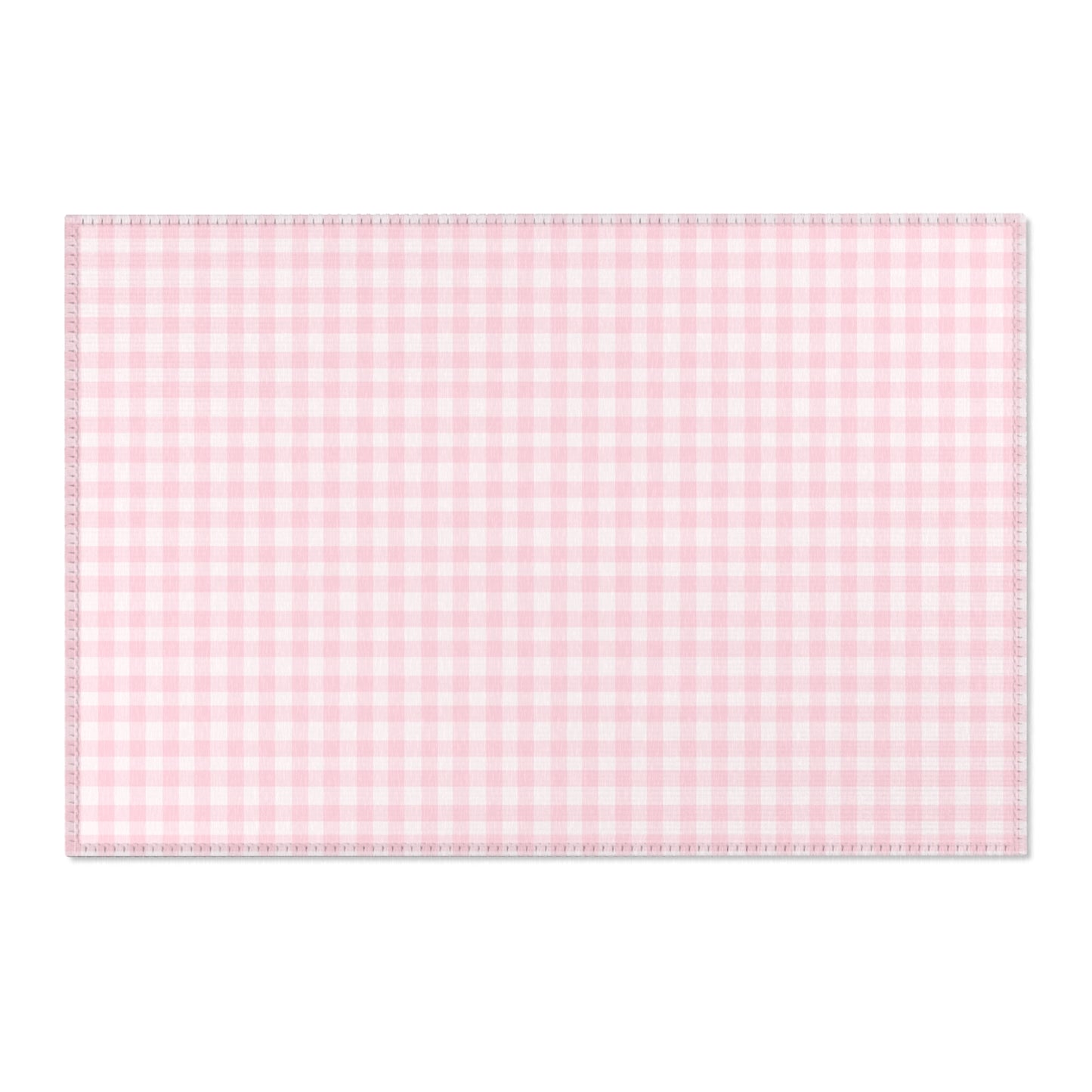 Pink gingham area rug beside a nursery crib