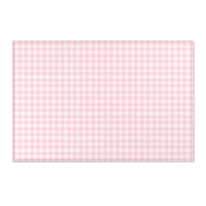 Pink gingham area rug beside a nursery crib