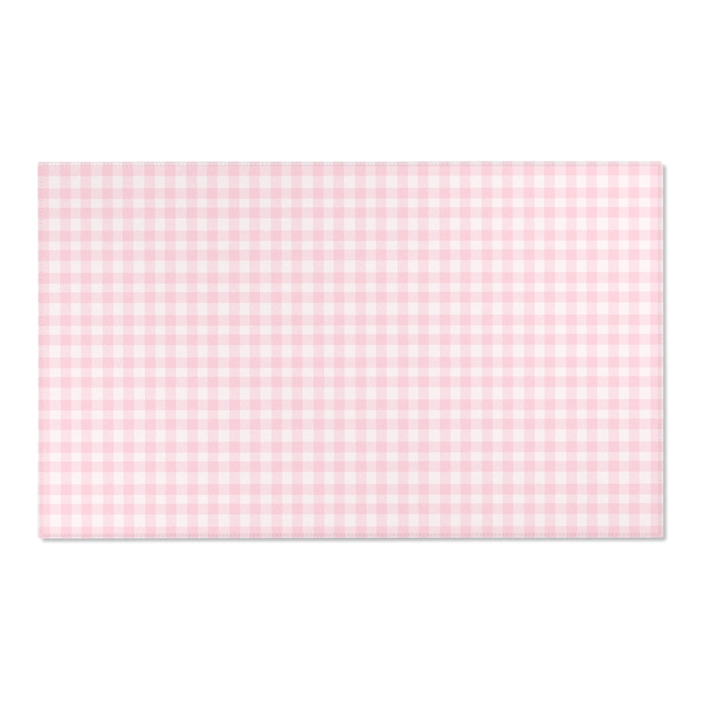 Blush Gingham area rug on a light wood floor