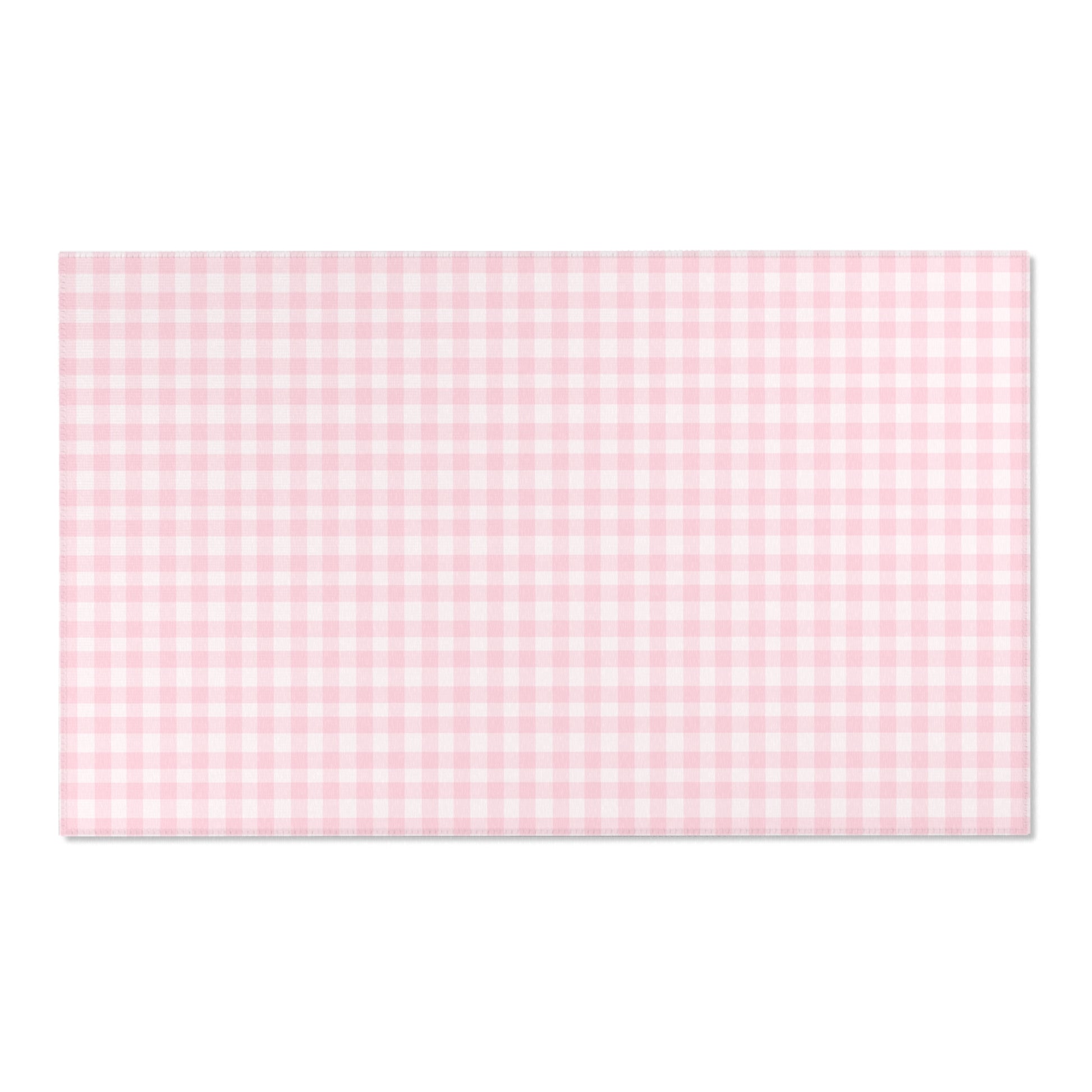 Blush Gingham area rug on a light wood floor
