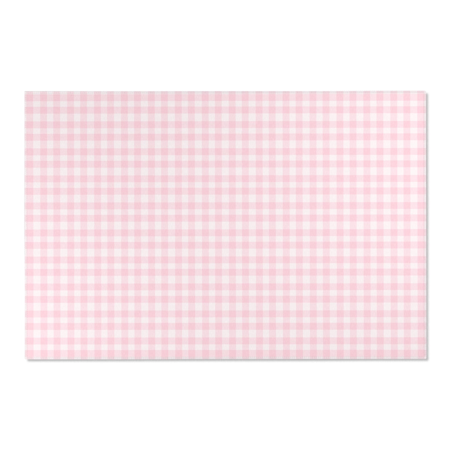 Soft pink check rug defining a nursery play area